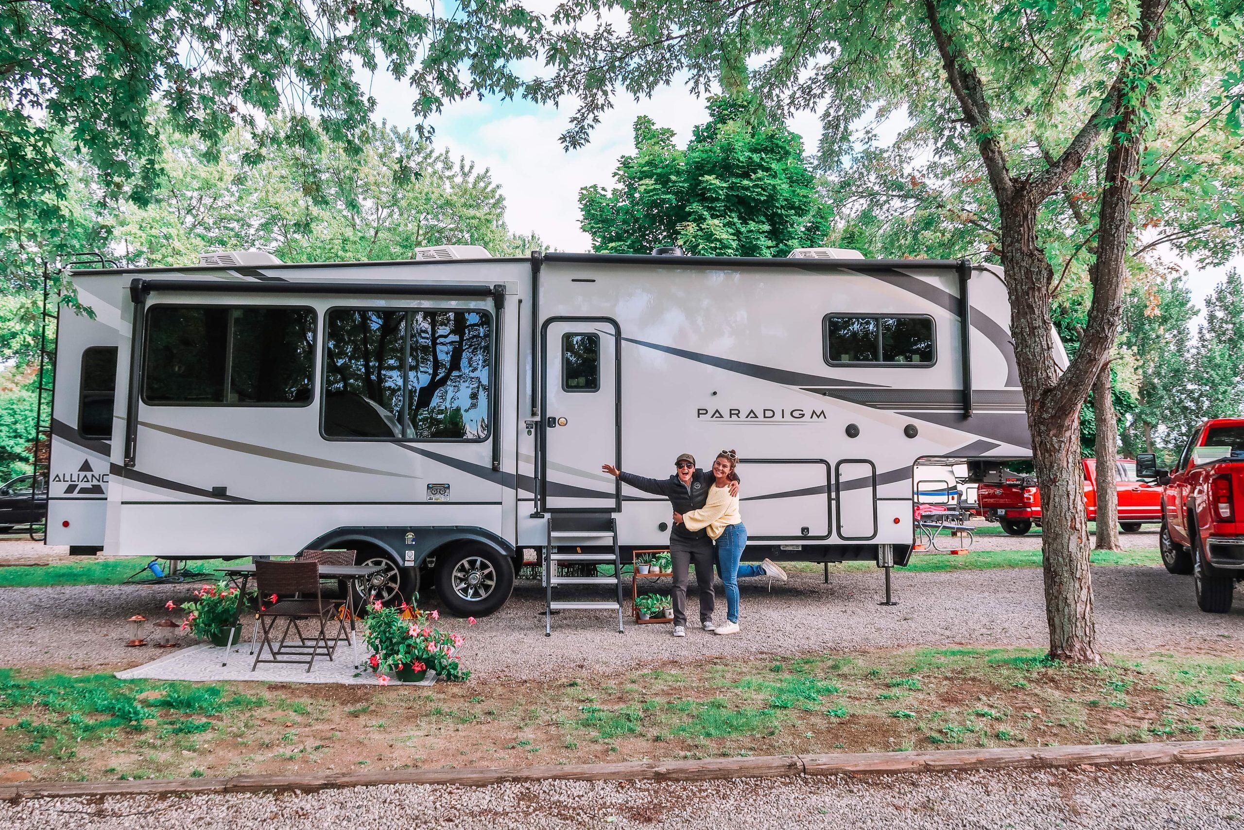 Two women in front of a fifth wheel